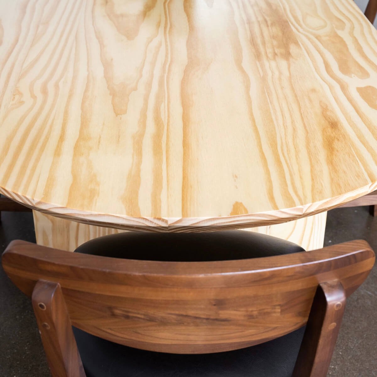 
                  
                    pine wood oval dining table up close
                  
                